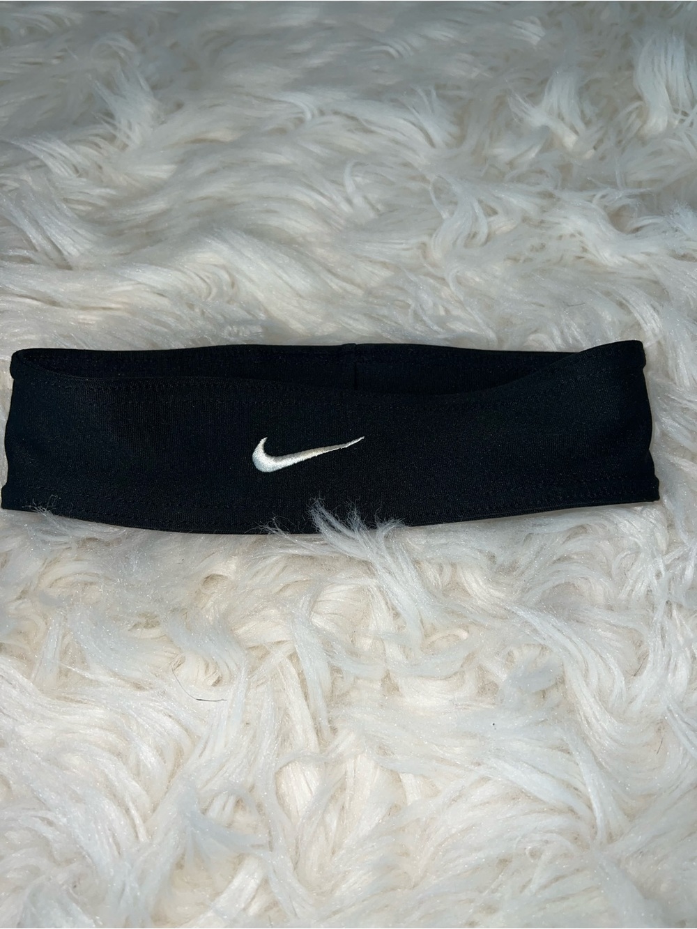 Black athletic headband with embroidered Nike Swoosh Stretch Athletic Sweatband